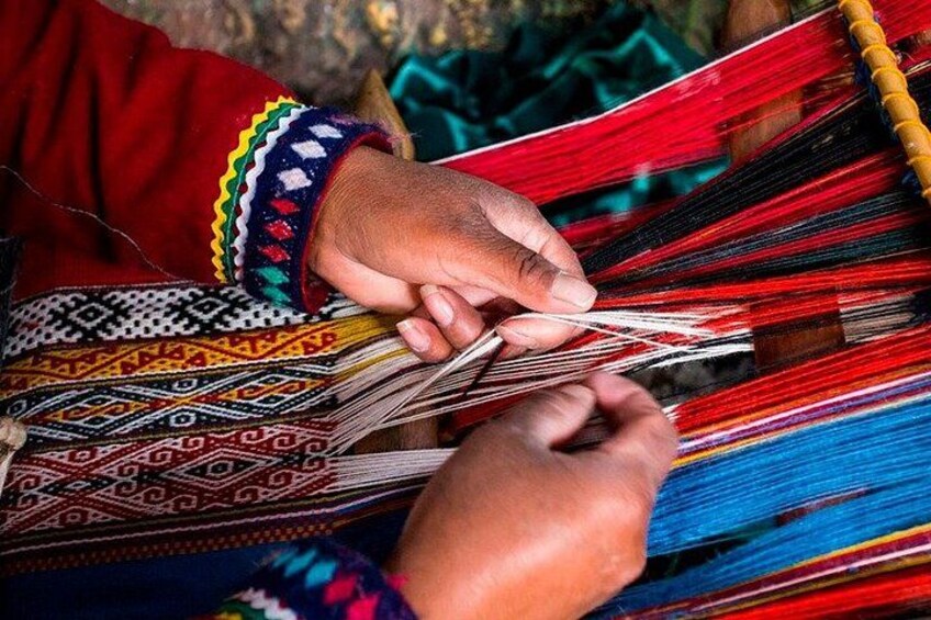 A person weaving colorful threads. 5