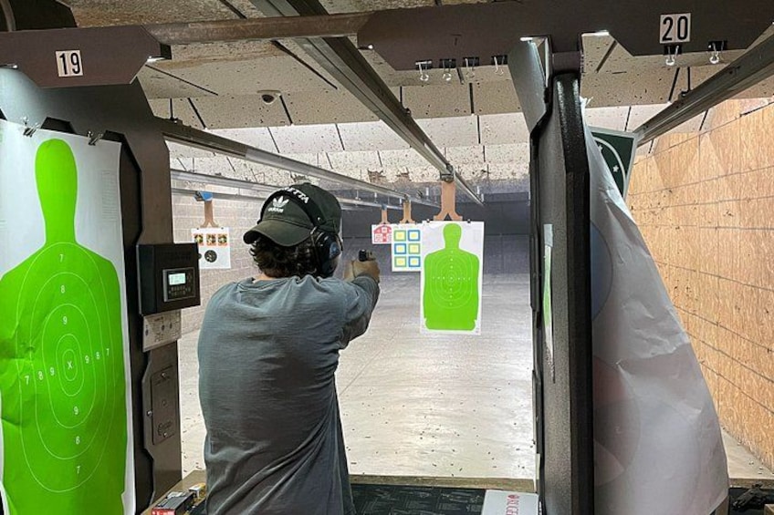 Sharp Shooters Indoor Range experience with a wall of guns 1