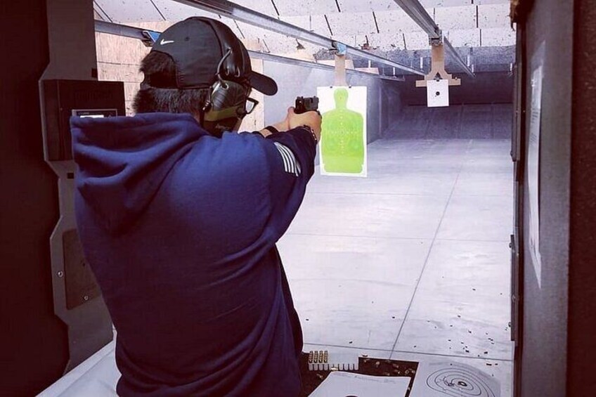 Sharp Shooters Indoor Range experience with a wall of guns 3