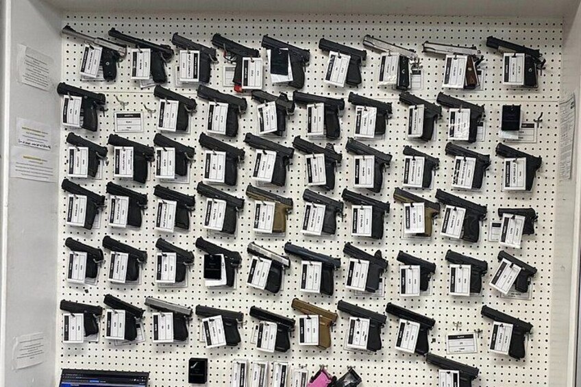Sharp Shooters Indoor Range experience with a wall of guns 3