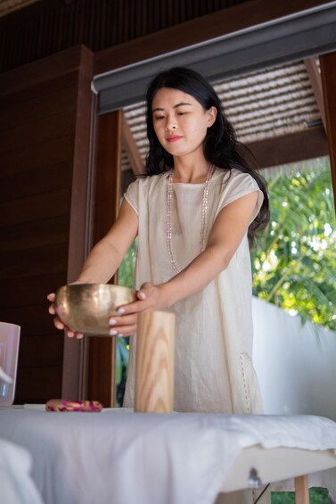 A person pouring a liquid from a bowl onto a table. 2