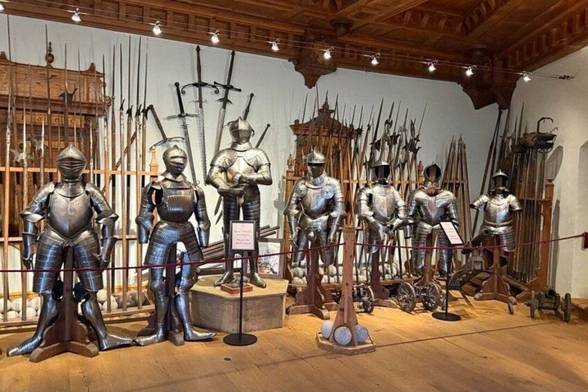A collection of medieval armor and weapons on display in a museum. 5