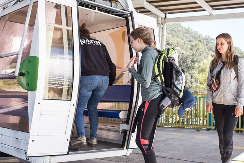 A person boarding a vehicle with a green seat and a white door. 1