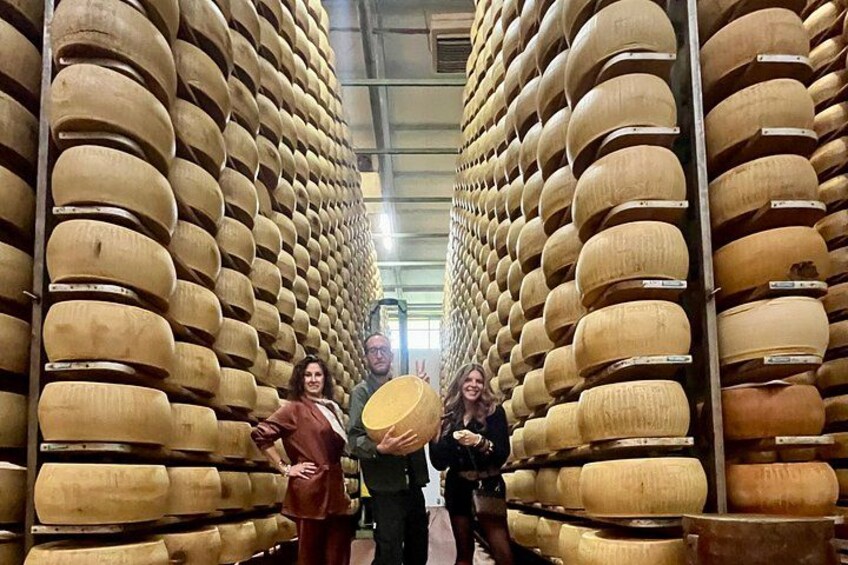 A storage room with large wooden barrels arranged in rows. 1