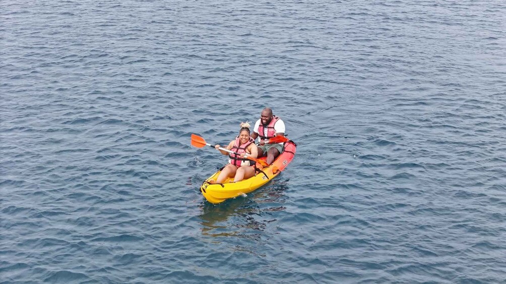 Two people kayaking on a calm sea. 3