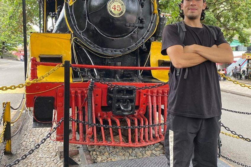 A person standing in front of a stationary train with a number 45 on its front. 4