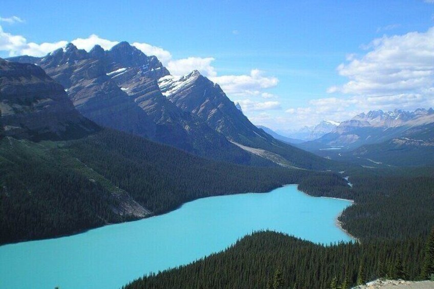 A mountain range, a turquoise lake, and dense forest. 5