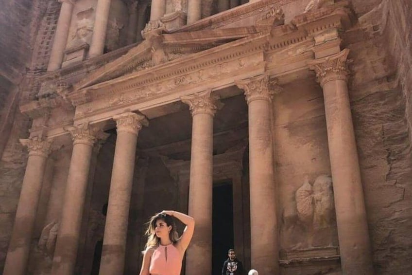 A large ancient structure with columns and detailed carvings. 2