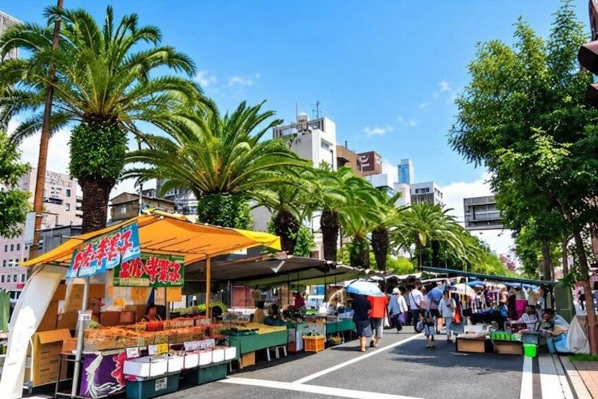 A street market with stalls selling fruits and vegetables. 3