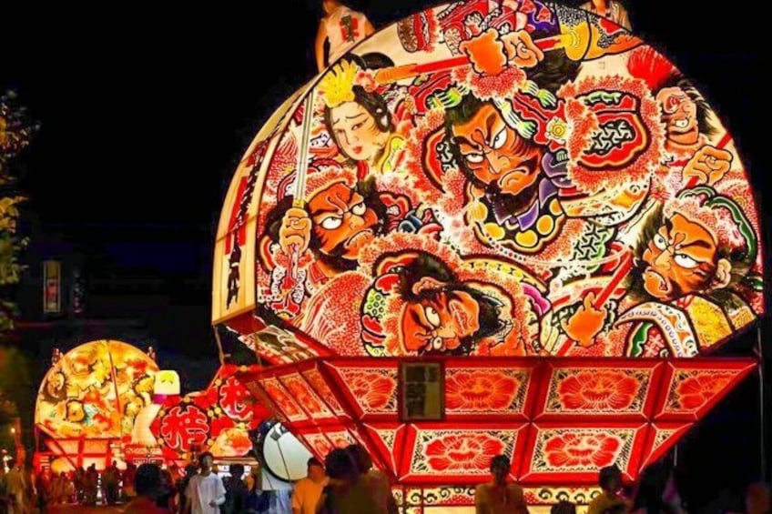 A large illuminated lantern with intricate designs and figures. 1
