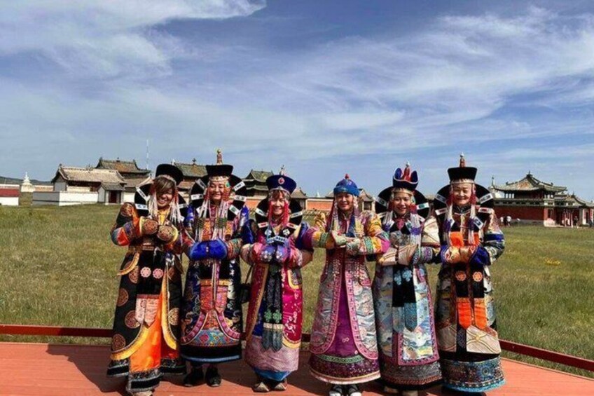 A group of people in colorful traditional costumes standing in a line. 1