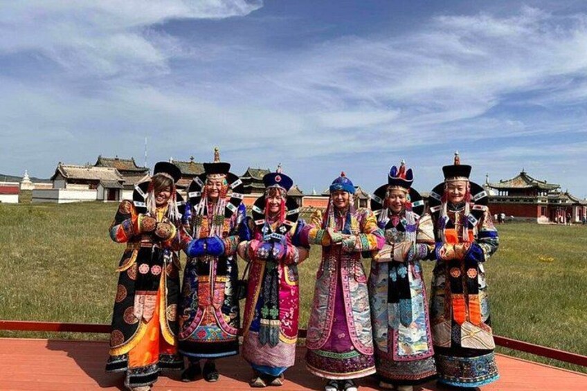 A group of people in traditional attire standing in a line. 1