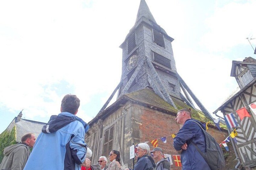A historic building with a clock tower, surrounded by people. 3