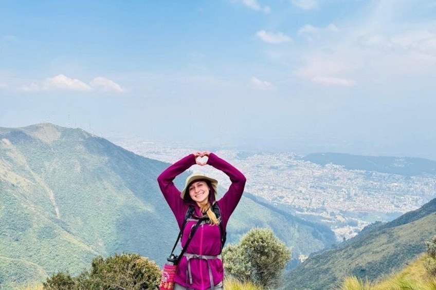 A person standing on a hill with a cityscape in the background. 1