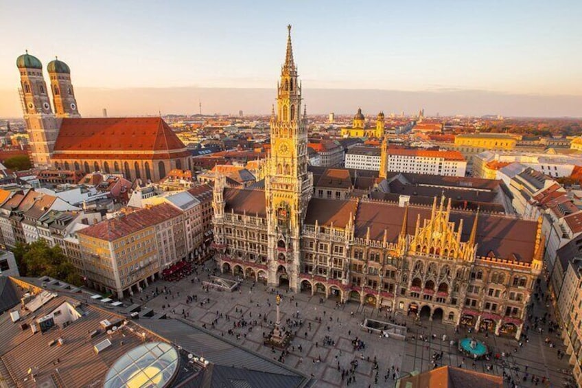 A historic city square with a prominent church and adjacent buildings. 1
