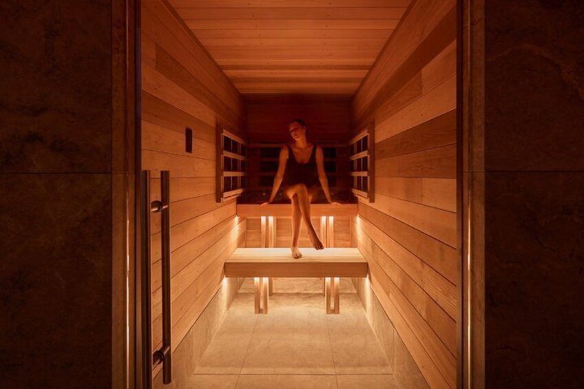 A sauna with wooden walls and benches. 5