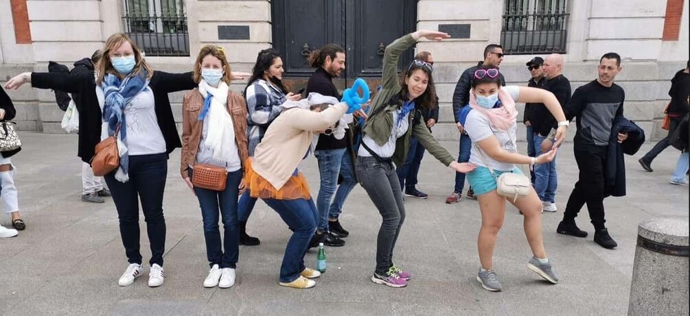 A group of people dancing in an outdoor urban setting. 1