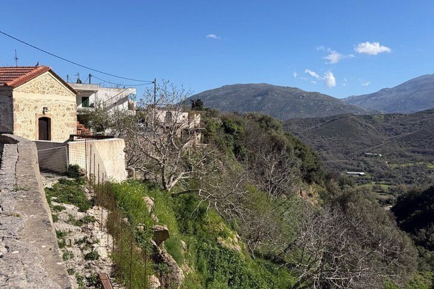 A stone building, a mountain landscape, and a clear sky. 3