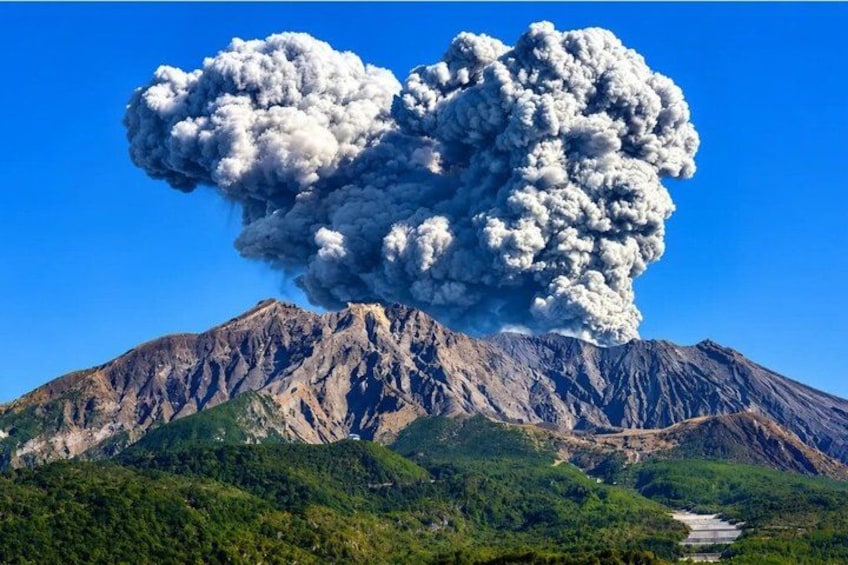 A volcano with a large plume of smoke and ash. 1