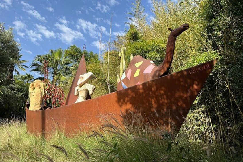 A boat with sculptures, surrounded by greenery and trees. 5