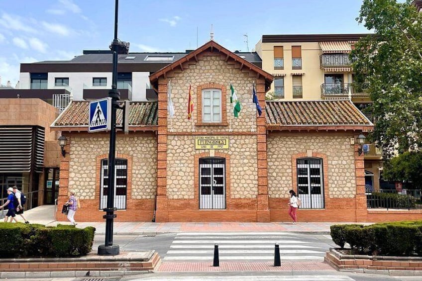 A stone building with a sign reading 'PRESIDIO' and flags. There is a pedestrian crossing in front. 2