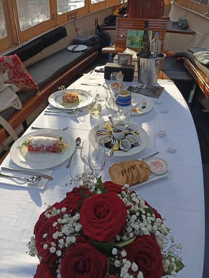 A table set with food and drinks on a boat. 4