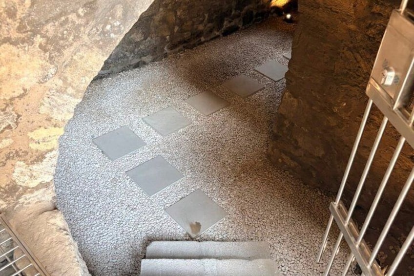 A stone staircase with a checkered pattern leading downwards. 3