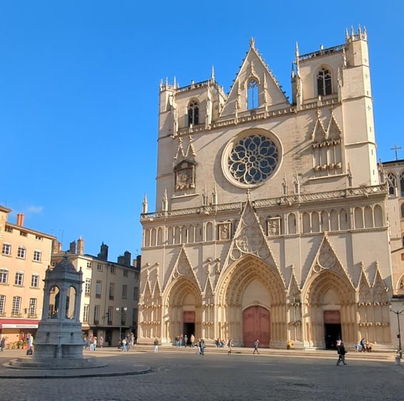 A historic cathedral with intricate Gothic architecture, a large rose window, and a central clock tower. 1