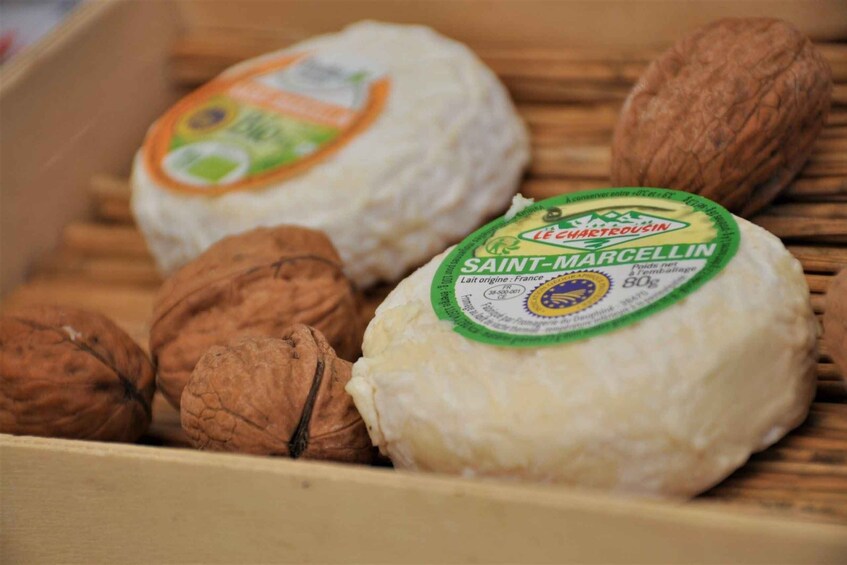 A box containing Saint-Marcellin cheese and walnuts. 5