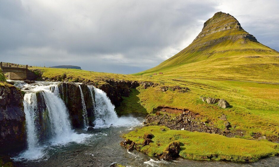 A waterfall, a bridge, and a hill. 3