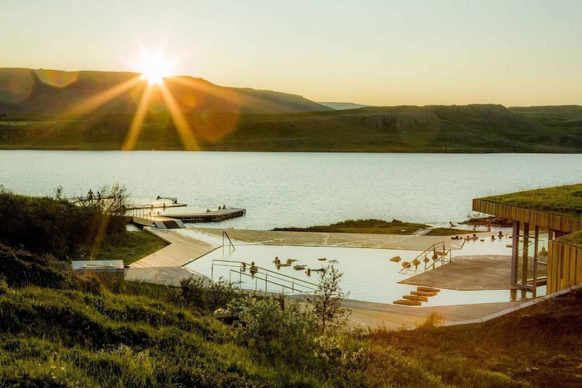 A lakeside swimming area with a wooden deck and a dock. 5