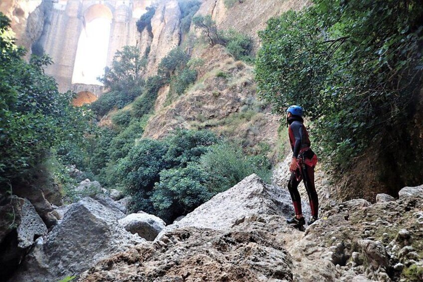 A person hiking on a rocky trail with a mountainous backdrop. 3