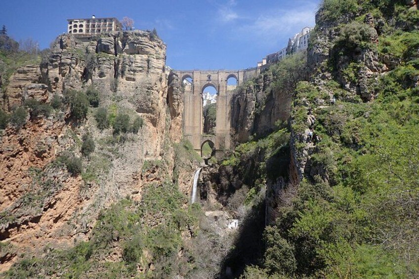 A canyon with a bridge and a waterfall. 2