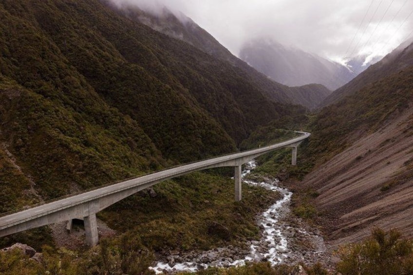 A bridge over a river in a mountainous area. 4