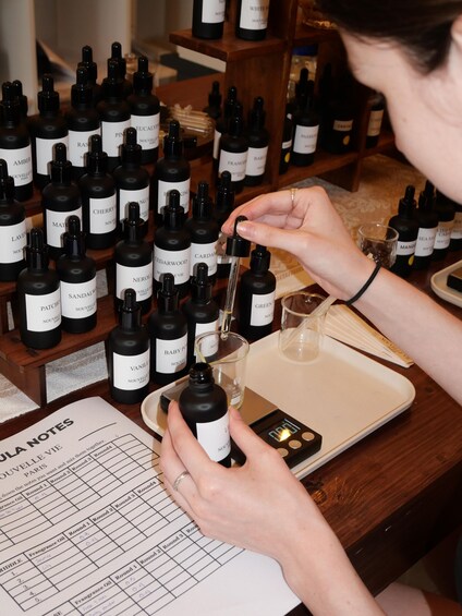 A person selecting a perfume from a display of bottles. 2