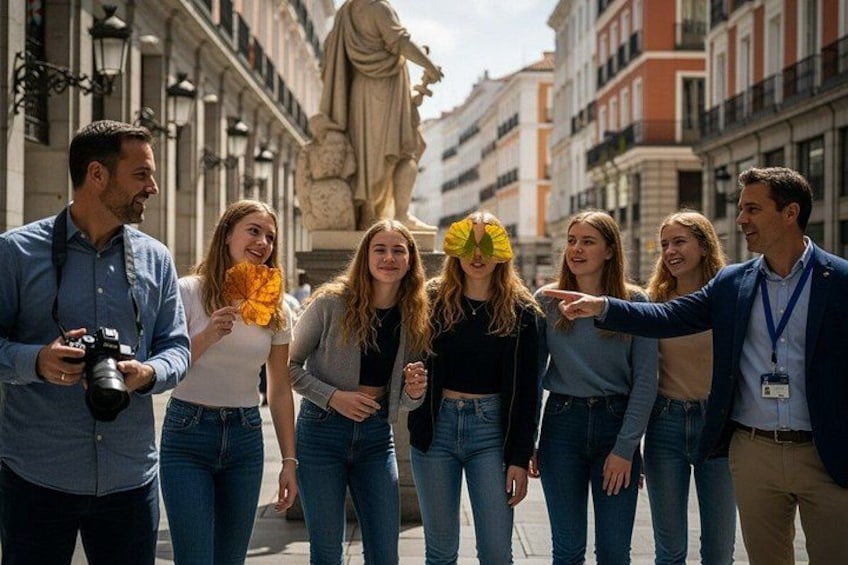 Een groep mensen loopt over een straat met gebouwen en een standbeeld op de achtergrond. 2