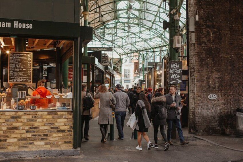 A busy street with people walking, a cafe named 'Sam House,' and a sign indicating a 'NEW HOT FOOD AREA.' 4
