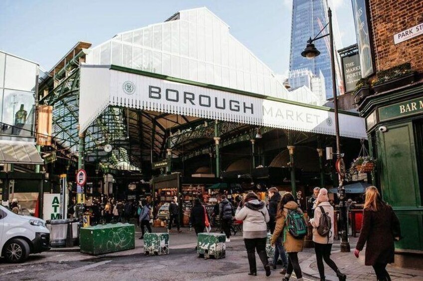 Borough Market with a covered entrance and people walking around. 1