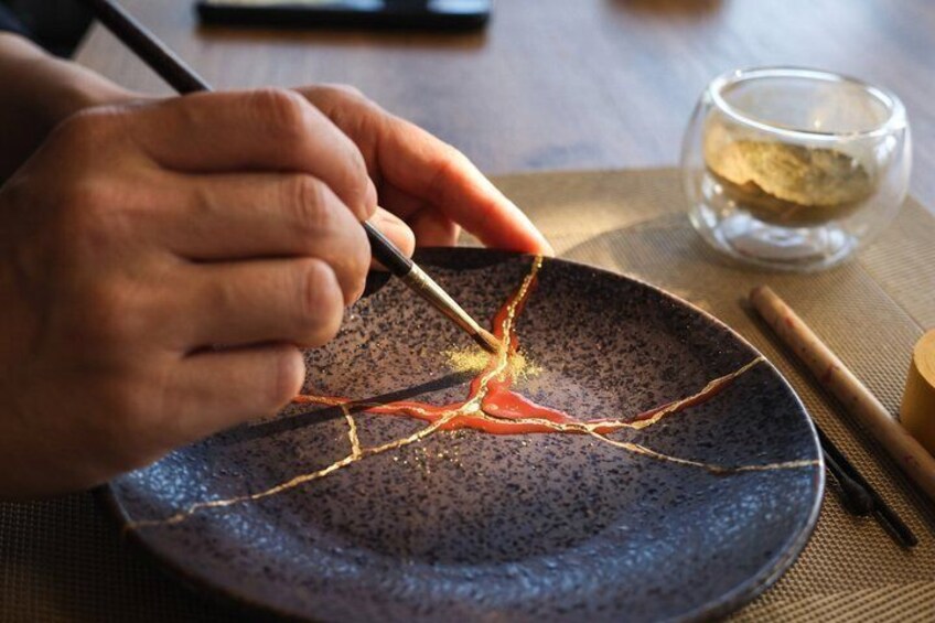 A person using chopsticks to pick up a thin noodle from a bowl. 1