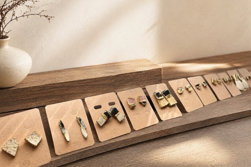 A display of various jewelry pieces on wooden boards. 4
