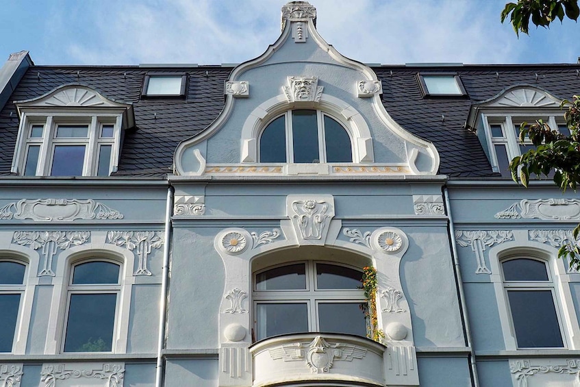 A building with ornate architectural details, including a prominent central archway and decorative moldings. 5