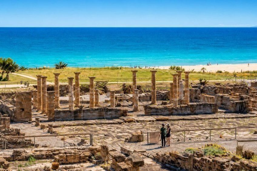 Ancient ruins by the sea with columns and a clear blue sky. 3