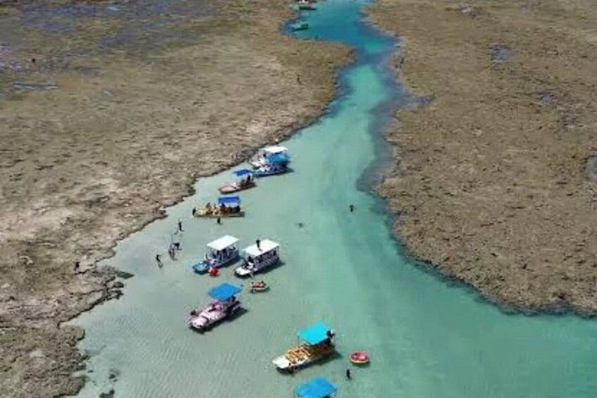 A river with boats and people. 1