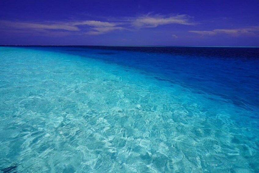Clear turquoise water, a calm sea, and a purple sky. 1
