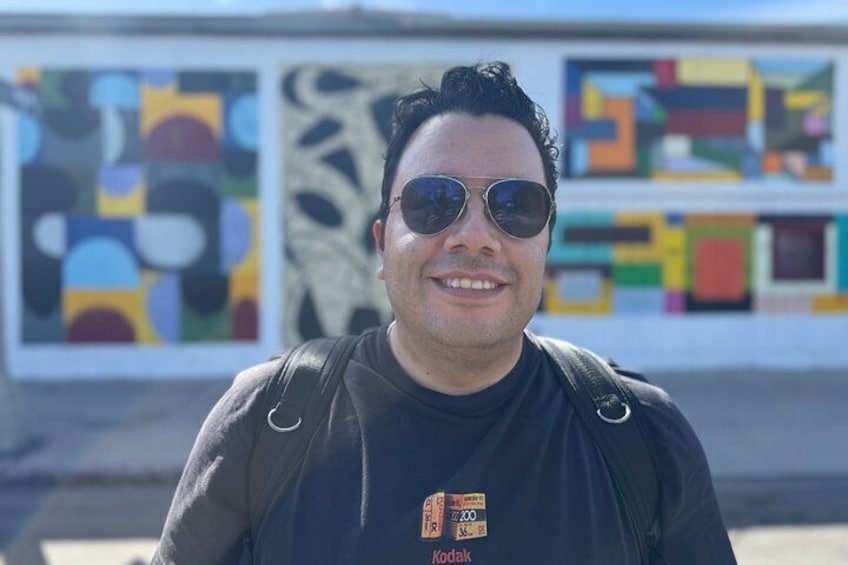 A person standing in front of an art installation with geometric patterns. 3