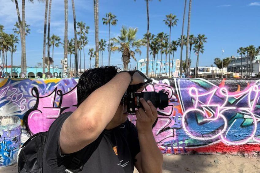 A person taking a photograph with a camera. 2