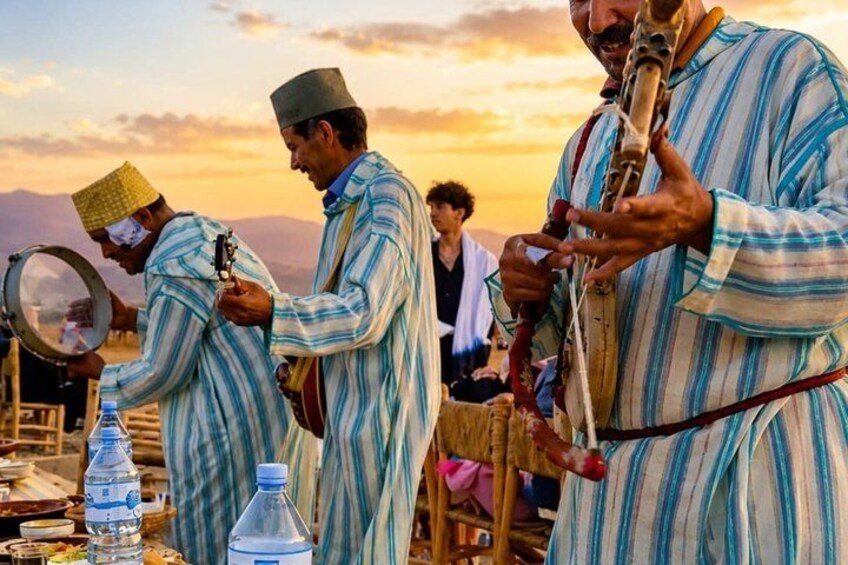 People in traditional striped clothing, a musical instrument, and a mirror. 2