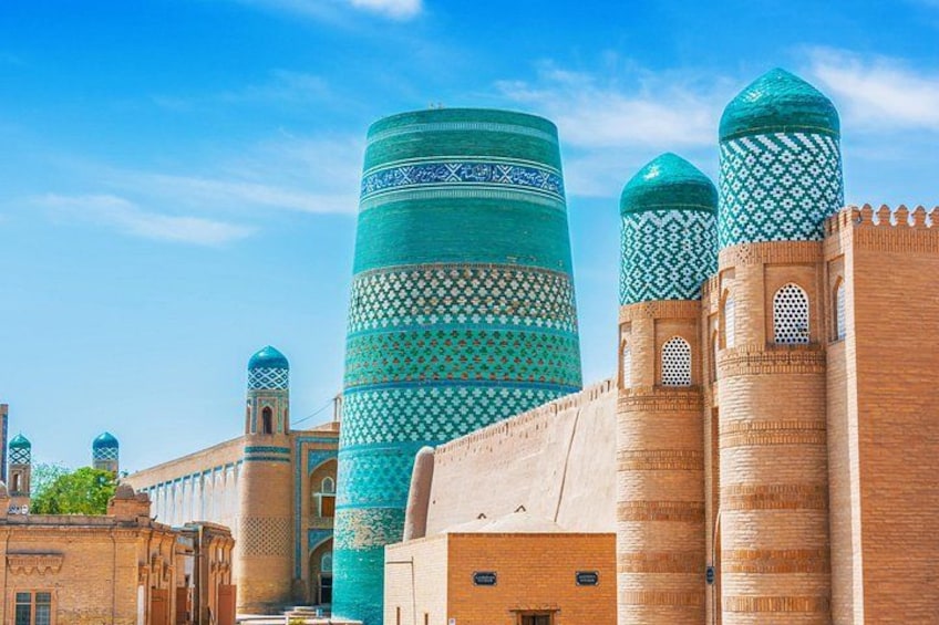 A historic building with tall, cylindrical towers and intricate blue patterns. 4