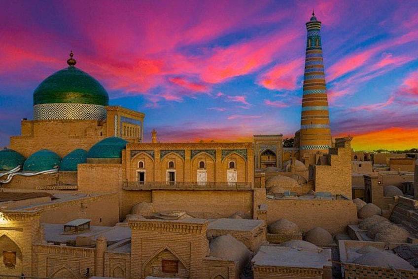 A historic cityscape with domed buildings and a minaret. 5