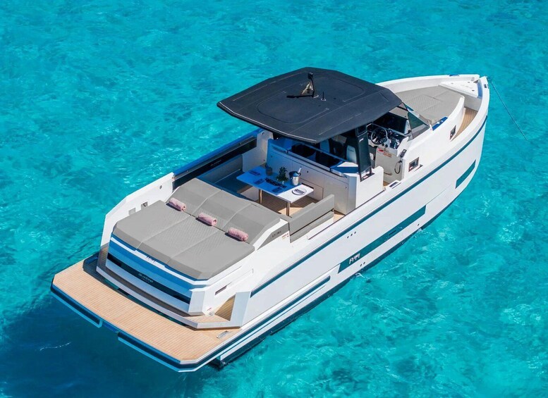 A yacht with a covered deck, lounge area, and a small table. 4